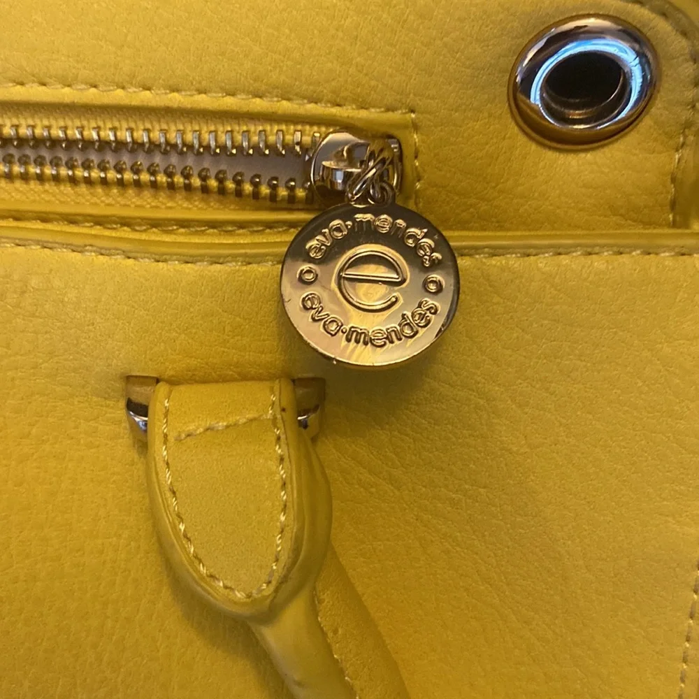 YELLOW EVA MENDES NEW YORK & COMPANY HANDBAG. It has 2 dividers with zippers.